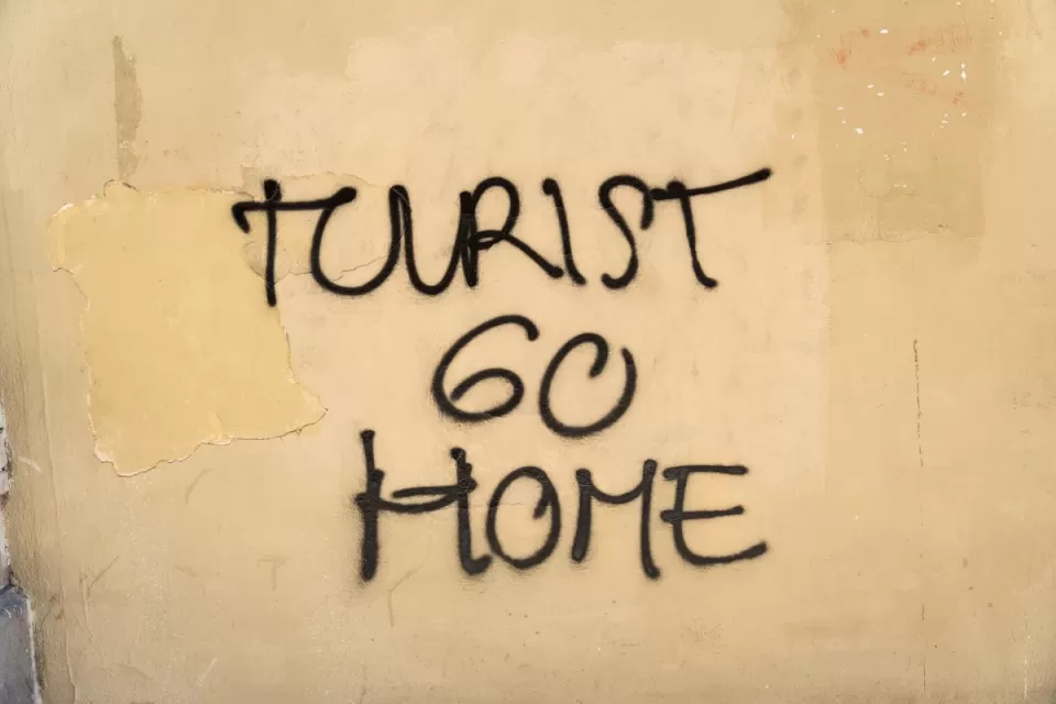"Tourist go home" graffiti on a wall in Barcelona, Spain.